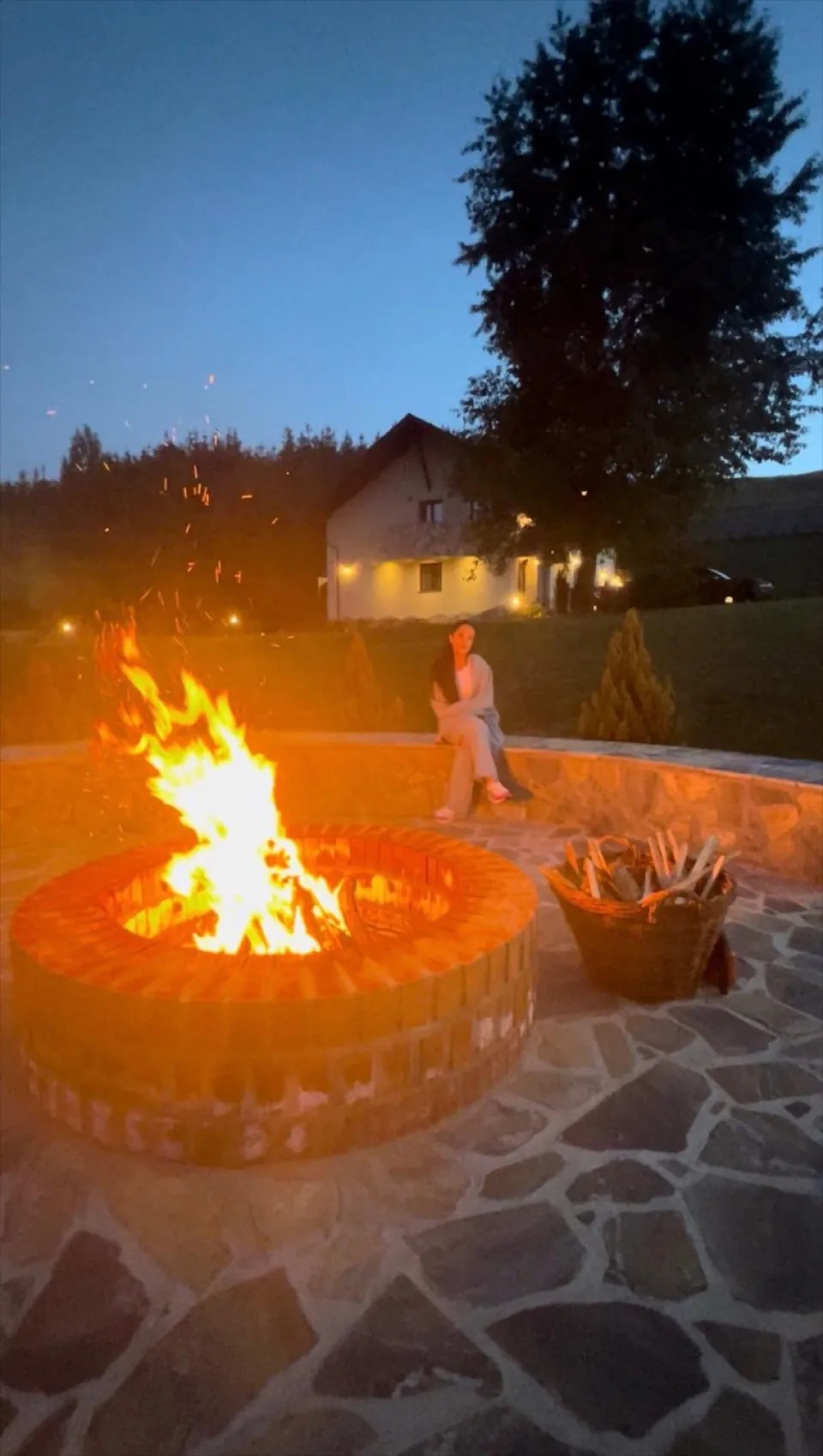 Vatra de foc aprinsă seara în grădina vilei